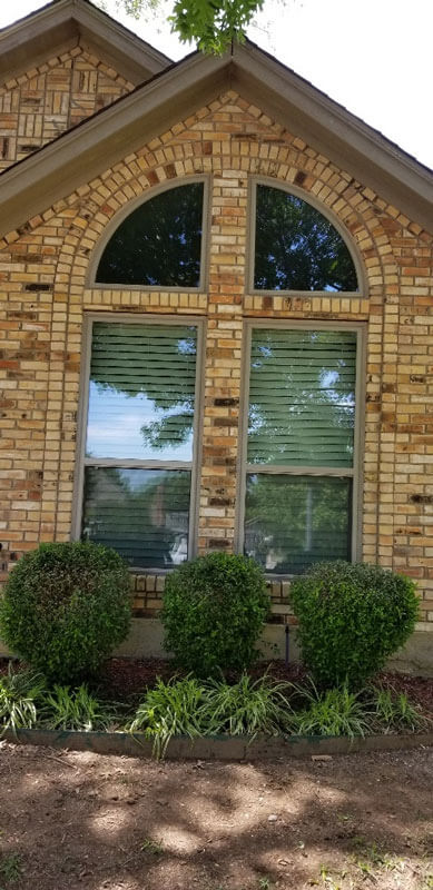 Arched window on brick house
